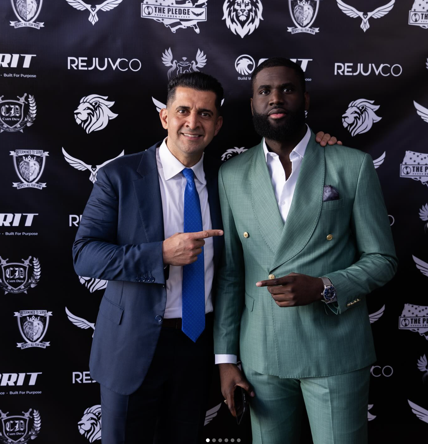 Okafor with Patrick Bet-David at a formal event